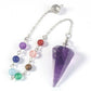 Silver pendulum with a large polished purple amethyst triangular point, attached to a chain with seven chakra gemstone beads (green aventurine, aquamarine, lapis lazuli, amethyst, rose quartz, carnelian, tiger's eye) and an ornate silver acorn charm. Chakra dowsing tool for divination and energy healing.