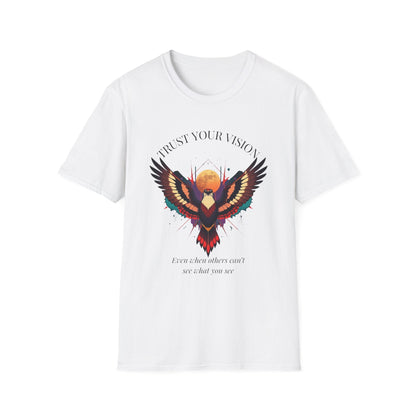 White unisex cotton t-shirt featuring bold motivational "Trust Your Vision" graphic: vibrant abstract phoenix/eagle with spread wings, intense expression, colorful geometric accents, and dynamic paint splatters in red, orange, teal, blue, and gold tones bursting outward around an orange moon background. Arched white text "TRUST YOUR VISION" above and smaller inspirational quote "Even when others can't see what you see" below. Spiritual empowerment crewneck tee.