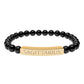 Bracelet with polished black onyx beads and gold-plated curved bar engraved "SAGITTARIUS" in uppercase letters. Stretch-fit zodiac-inspired crystal jewelry for adventure, optimism, and truth-seeking.