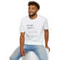 White unisex cotton t-shirt modeled by smiling man with curly hair and beard, featuring bold Life Path Number 22 numerology print in dictionary style: exact text reading "Life Path Number 22 noun · Master vibration of vision, mastery, and monumental building. · Architect of impact — here to turn grand dreams into enduring reality. – see also: build, manifest, legacy". Motivational spiritual numerology crewneck tee.