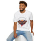 White unisex cotton t-shirt modeled by smiling man with curly hair and beard, featuring bold "Follow Your Light" graphic: vibrant abstract moth/butterfly with detailed wings, intense expression, colorful geometric accents, and dynamic paint splatters in red, orange, teal, blue, and gold tones around an orange moon. Arched white text "FOLLOW YOUR LIGHT" above and smaller quote "Even when others can't see where you're going, see with your own eyes" below. Motivational spiritual empowerment crewneck tee.