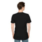 Black unisex cotton crewneck t-shirt back view on male model with short brown hair: plain blank black with no print, short sleeves, relaxed fit, and clean hem. Soft comfortable premium basic black t-shirt rear view.