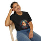 Black unisex cotton t-shirt modeled by smiling woman with braided hair, hand on cheek, featuring bold "Feral" graphic on chest: vibrant abstract portrait of a fierce woman with wild flowing hair, intense expression, tribal markings, colorful geometric accents, and dynamic paint splatters in red, orange, teal, blue, and gold tones bursting outward around an orange moon background. White elegant cursive "Feral" text below. Wild feminine energy motivational crewneck tee.