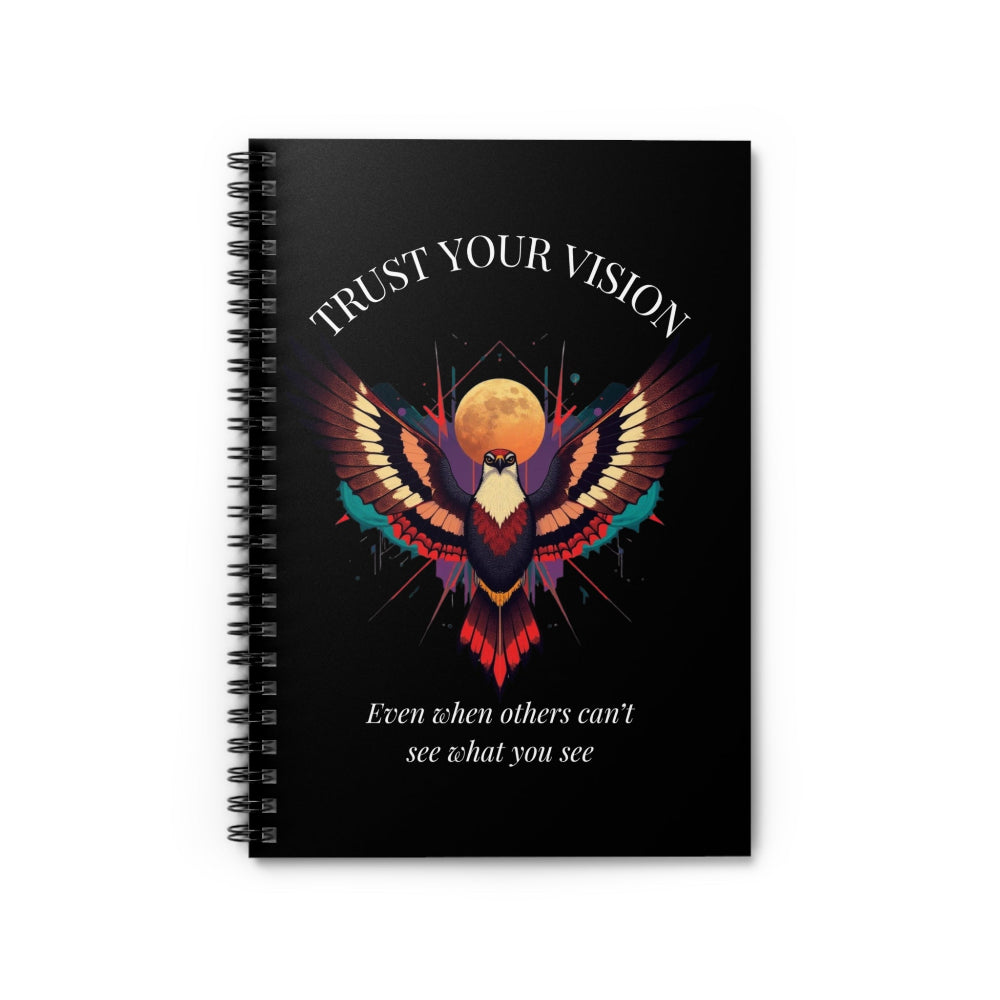 Close up of notebook with a colorful abstract phoenix/eagle with spread wings, intense expression, and paint splatters on a black background, featuring the words "TRUST YOUR VISION" and quote "Even when others can't see what you see".