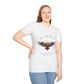 White plus-size unisex cotton t-shirt modeled by smiling woman with long blonde hair, hand on hip, featuring bold "Trust the Silence" graphic: vibrant abstract owl with detailed feathers, intense expression, colorful geometric accents, and dynamic paint splatters in red, orange, teal, blue, and gold around an orange moon. Arched white text "TRUST THE SILENCE" above and smaller quote "Even when the world is quiet, wisdom speaks softly" below. Motivational spiritual empowerment crewneck tee.