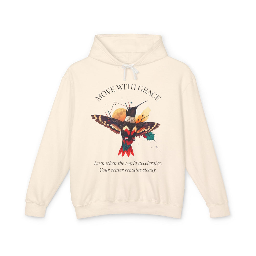 Cream hoodie with 'Move With Grace' inspirational hummingbird graphic and quote 'Even when the world accelerates, Your center remains steady' printed on the front.
