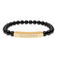 Bracelet with polished black onyx beads and gold-plated curved bar engraved "SCORPIO" in uppercase letters. Stretch-fit zodiac-inspired crystal jewelry for intensity, transformation, and emotional depth.