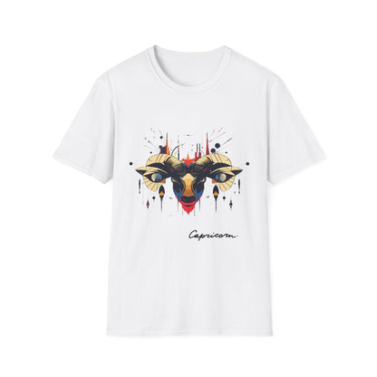 White unisex cotton t-shirt featuring bold Capricorn zodiac graphic: vibrant abstract goat/ram head portrait with large curved horns, intense glowing eyes, geometric diamond accents, flowing beard details, and dynamic multicolored paint splatters in gold, red, navy, teal, and black tones exploding outward. Elegant black cursive "Capricorn" text below. Astrology zodiac motivational crewneck tee.