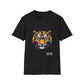 Black unisex cotton t-shirt featuring bold Year of the Tiger graphic: vibrant abstract tiger face portrait with fierce intense eyes, detailed stripes, symmetrical design, large ears, and dynamic multicolored paint splatters in yellow, orange, red, blue, black and teal tones exploding outward. Chinese text "虎年" (Year of the Tiger) printed below in white. Zodiac Chinese New Year motivational crewneck tee.