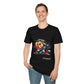 Black unisex cotton t-shirt modeled by smiling man with hand in pocket, featuring bold "Primal" graphic: stylized intense bearded man portrait with styled hair, intense upward gaze, and vibrant multicolored geometric shards in red, yellow, teal, and blue exploding outward. Elegant white cursive "Primal" text below. Primal masculine energy motivational crewneck tee.