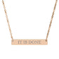 Rose gold bar necklace with engraved uppercase text "IT IS DONE" on a sleek matte pendant, suspended on a delicate matching rose gold chain. Minimalist motivational affirmation jewelry for manifestation and completion.