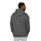 Back view of a man wearing charcoal gray hoodie, plain solid fabric with no print or design, hood up