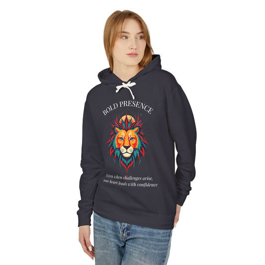 Young woman with long hair modeling charcoal gray hoodie featuring vibrant multicolored lion head graphic, mane in orange teal blue splashes, "BOLD PRESENCE" arched text, motivational quote about heart-led confidence below