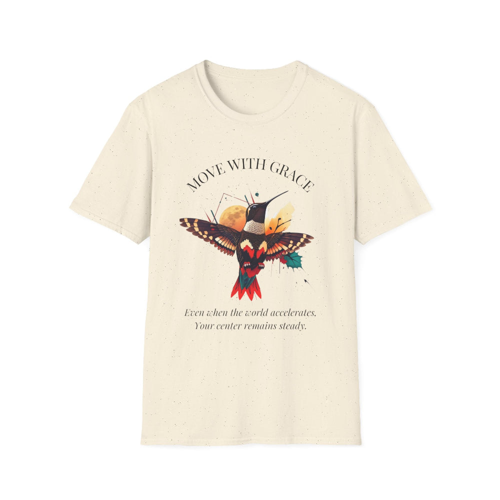 Cream speckled t-shirt featuring a vibrant hummingbird graphic with the text "MOVE WITH GRACE" arched above and the quote "Even when the world accelerates, Your center remains steady" below. Motivational spiritual apparel.