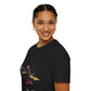 Black unisex cotton t-shirt in side profile on smiling woman with braided hair, featuring bold Sagittarius zodiac graphic on chest: vibrant abstract archer silhouette drawing bow, dynamic warrior pose with flowing cape, intricate armor details, and explosive multicolored paint splatters in gold, red, navy, teal, and black tones bursting outward. Elegant white cursive "Sagittarius" text below. Astrology zodiac motivational crewneck tee.
