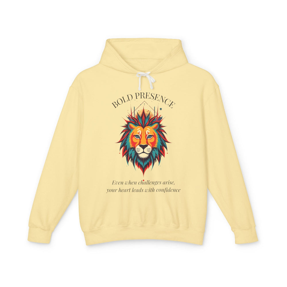 Light yellow hoodie with vibrant colorful lion head graphic, mane in orange teal blue splashes, "BOLD PRESENCE" arched text above, motivational quote "Even when challenges arise, your heart leads with confidence" below