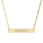 Gold bar necklace with engraved uppercase text "SACRED" on a sleek matte pendant, suspended on a delicate matching gold chain. Minimalist spiritual affirmation jewelry for sacred energy and divine connection.