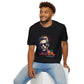 Black unisex cotton t-shirt modeled by smiling man with curly hair and beard, featuring bold "Primal" graphic: stylized intense man portrait with vibrant red, orange, yellow, blue paint splatters bursting outward. Elegant white "Primal" text below. Primal masculine energy motivational crewneck tee.