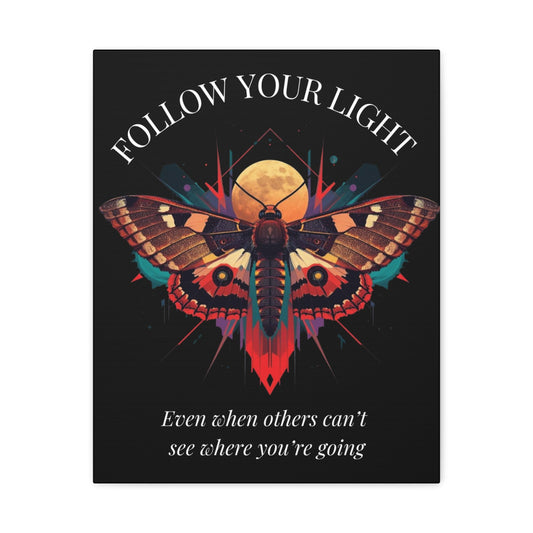 Close up of black canvas wall art print featuring colorful abstract moth with detailed wings, intense expression, geometric accents, and cosmic splatters on dark background. Arched white text "FOLLOW YOUR LIGHT" above and quote "Even when others can't see where you're going, see with your own eyes" below. 