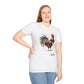 White unisex cotton t-shirt modeled by smiling plus-size female with long blonde hair, hand on hip, featuring bold Year of the Rooster zodiac graphic: vibrant abstract rooster portrait with detailed feathers, proud stance, intense eyes, red comb and wattles, geometric accents, and dynamic multicolored paint splatters in gold, red, black, blue, teal, and orange tones exploding outward. Chinese text "鸡年" (Year of the Rooster) printed below in black. Zodiac Chinese New Year motivational crewneck tee.