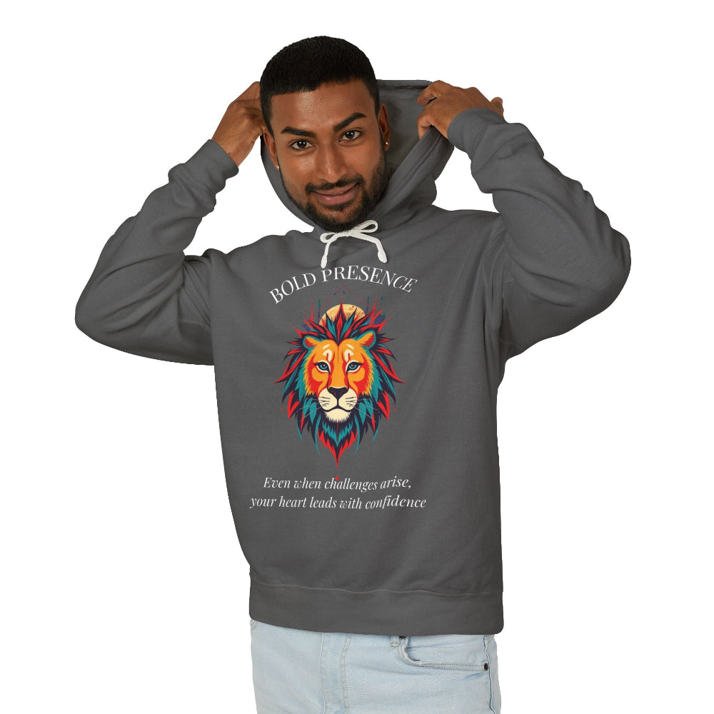 Young man with short hair pulling up the hood of a Dark gray hoodie featuring vibrant artistic print of a fierce woman with long flowing hair, red-orange armored top, colorful paint splash design, "Feral" text below