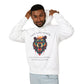 Young man with short hair pulling up the hood of a white hoodie featuring vibrant multicolored bear head graphic, roaring expression, orange moon above, "GROUNDED POWER" arched text, motivational quote about roots and steadiness below