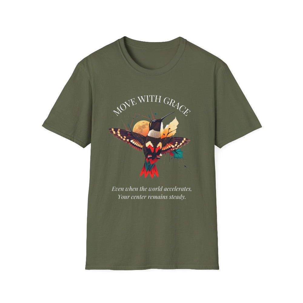 Olive green t-shirt featuring a vibrant hummingbird graphic with the text "MOVE WITH GRACE" arched above and the quote "Even when the world accelerates, Your center remains steady" below. Motivational spiritual apparel.