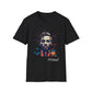 Black unisex cotton t-shirt laid out flat featuring bold "Primal" graphic: stylized intense male portrait with stylish hair, vibrant multicolored geometric face in red, orange, teal, blue and gold tones, dynamic paint splatters and abstract shards exploding outward. Elegant white cursive "Primal" text below. Primal masculine energy motivational crewneck tee.
