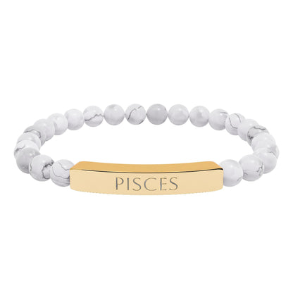 Bracelet with polished white howlite beads featuring natural gray-black veining and marbling, paired with a gold-plated curved bar engraved "PISCES" in uppercase letters. Stretch-fit zodiac-inspired crystal jewelry.