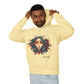 Young man with short hair pulling up the hood of a pale yellow hoodie featuring vibrant artistic portrait of a fierce woman with curly multicolored flowing hair, teal red blue orange face accents, large hoop earrings, third-eye symbol, "Feral" text below