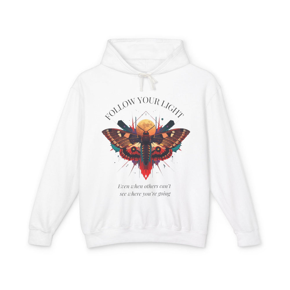 White hoodie with vibrant multicolored moth/butterfly graphic, geometric sun/moon elements, "FOLLOW YOUR LIGHT" arched text above, motivational quote "Even when others can't see where you're going" below