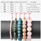 Bracelet size guide chart showing five crystal bead bracelets in different sizes on a black cylinder: 4mm (pink), 6mm (green), 8mm (blue apatite), 10mm (rose quartz), and 12mm (pink). Table below lists particle size, number of beads, inner girth, and fit recommendations for men and women (e.g., 4mm for thin wrists, 12mm for even shapes). Clear visual comparison for sizing crystal bracelets.