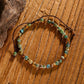 Turquoise and mixed gemstone wrap bracelet: faceted round beads in earthy turquoise, brown, orange, and green tones with natural veining, gold spacers, adjustable brown cord tie closure, displayed on wooden background. Boho handmade crystal jewelry for grounding and protection.