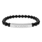 Bracelet with polished black onyx beads and silver curved bar engraved "SCORPIO" in uppercase letters. Stretch-fit zodiac-inspired crystal jewelry for intensity, transformation, and emotional depth.