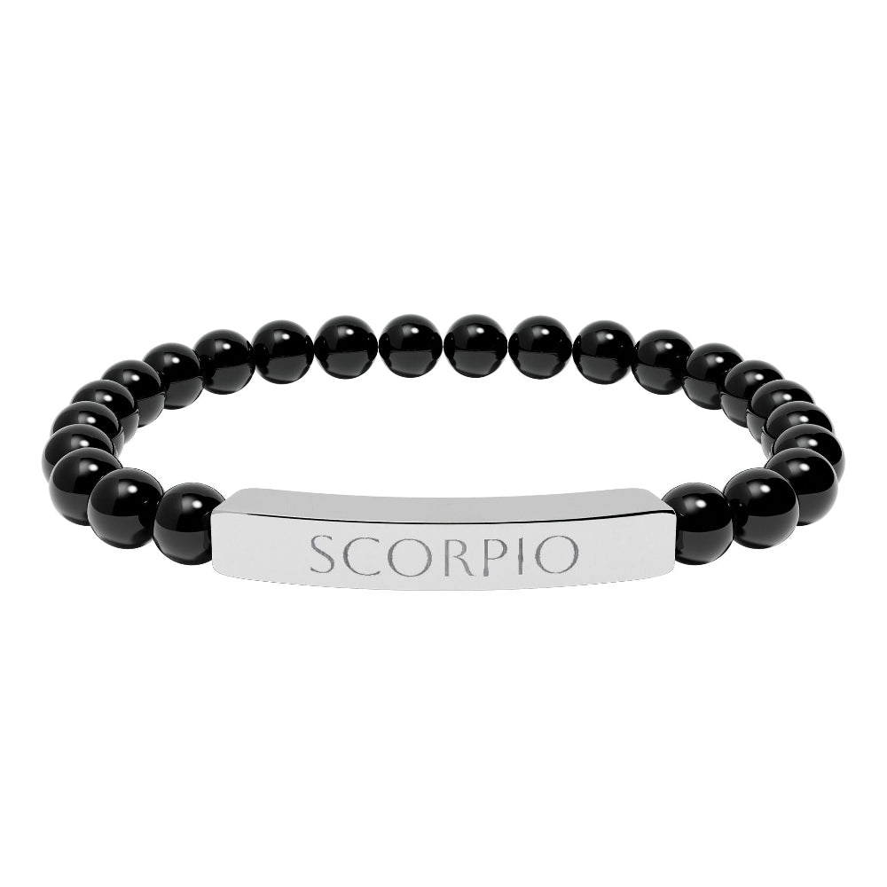 Bracelet with polished black onyx beads and silver curved bar engraved "SCORPIO" in uppercase letters. Stretch-fit zodiac-inspired crystal jewelry for intensity, transformation, and emotional depth.