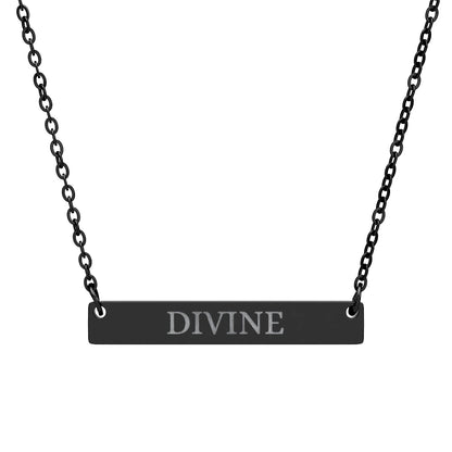 Black bar necklace with engraved uppercase text "DIVINE" on a matte black pendant, suspended on a delicate black chain. Minimalist spiritual affirmation jewelry for empowerment and divine connection.