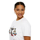 White unisex cotton t-shirt in side profile on smiling woman with braided hair, featuring bold Libra zodiac graphic on chest: vibrant abstract scales of justice with balanced arms, intricate geometric triangular motifs, central axis, symmetrical design, and dynamic multicolored paint splatters in gold, red, navy, teal, and black tones bursting outward. Elegant black cursive "Libra" text below. Astrology zodiac motivational crewneck tee.
