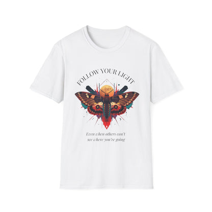 White unisex cotton t-shirt featuring bold "Follow Your Light" graphic: vibrant abstract moth with detailed wings, intense expression, colorful geometric accents, and dynamic paint splatters in red, orange, teal, blue, and gold tones bursting outward around an orange moon background. Arched white text "FOLLOW YOUR LIGHT" above and smaller inspirational quote "Even when others can't see where you're going, see with your own eyes" below. Motivational spiritual empowerment crewneck tee.