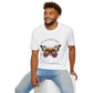 White unisex cotton t-shirt modeled by smiling man with curly hair and beard, featuring bold "Transformation" graphic: vibrant abstract butterfly with detailed wings, intense expression, colorful geometric accents, and dynamic paint splatters in red, orange, teal, blue, and gold tones around an orange moon. Arched white text "TRANSFORMATION" above and smaller quote "Even when progress feels impossible, you are becoming free" below. Motivational spiritual empowerment crewneck tee.