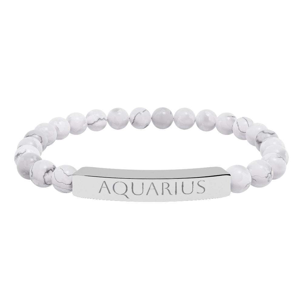 Bracelet with polished white howlite beads featuring natural gray-black veining and marbling, paired with a silver curved bar engraved "AQUARIUS" in uppercase letters. Stretch-fit zodiac-inspired crystal jewelry.