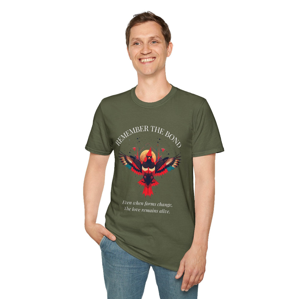 Man modeling an olive green t-shirt with 'Remember The Bond' inspirational bird graphic and quote 'Even when forms change, The love remains alive' printed on the front.