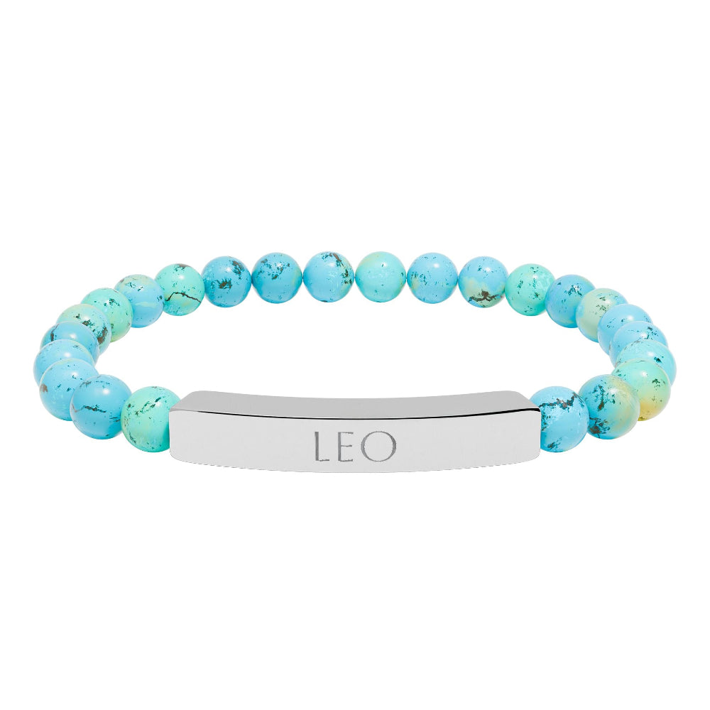 Bracelet with polished turquoise beads in soft aqua-blue tones with natural veining and speckles, featuring a silver curved bar engraved "LEO" in uppercase letters. Stretch-fit zodiac-inspired crystal jewelry.