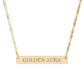 Gold bar necklace with engraved uppercase text "GOLDEN AURA" on a sleek matte pendant, suspended on a delicate matching gold chain. Minimalist motivational affirmation jewelry for radiance, positivity, and energetic glow.