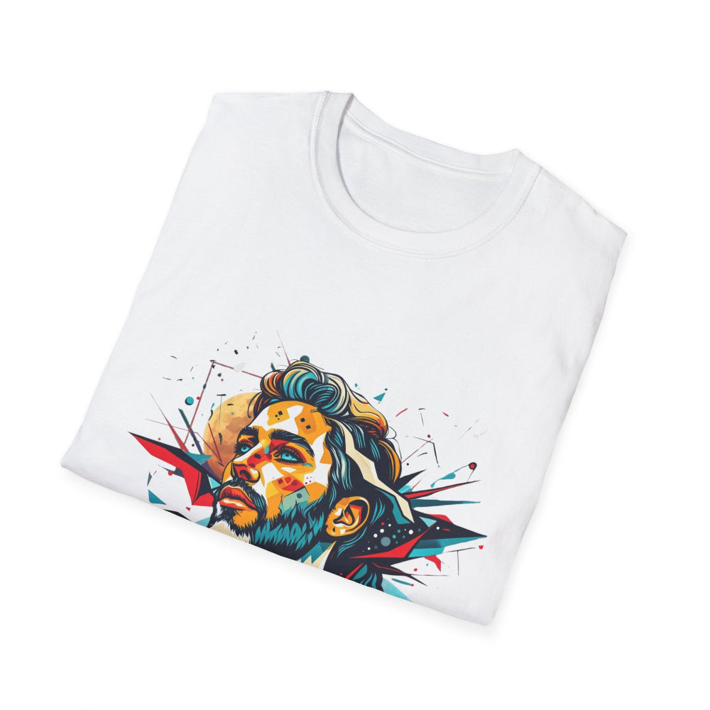 White folded unisex cotton t-shirt featuring bold Primal graphic: stylized bearded man portrait with styled hair, intense upward gaze, and vibrant multicolored geometric shards in red, yellow, teal, and blue exploding outward. Primal masculine energy motivational crewneck tee.