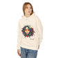 Young woman with long hair modeling cream hoodie featuring vibrant artistic portrait of a fierce woman with curly multicolored flowing hair, teal and red face accents, hoop earrings, geometric backdrop, "Feral" text below