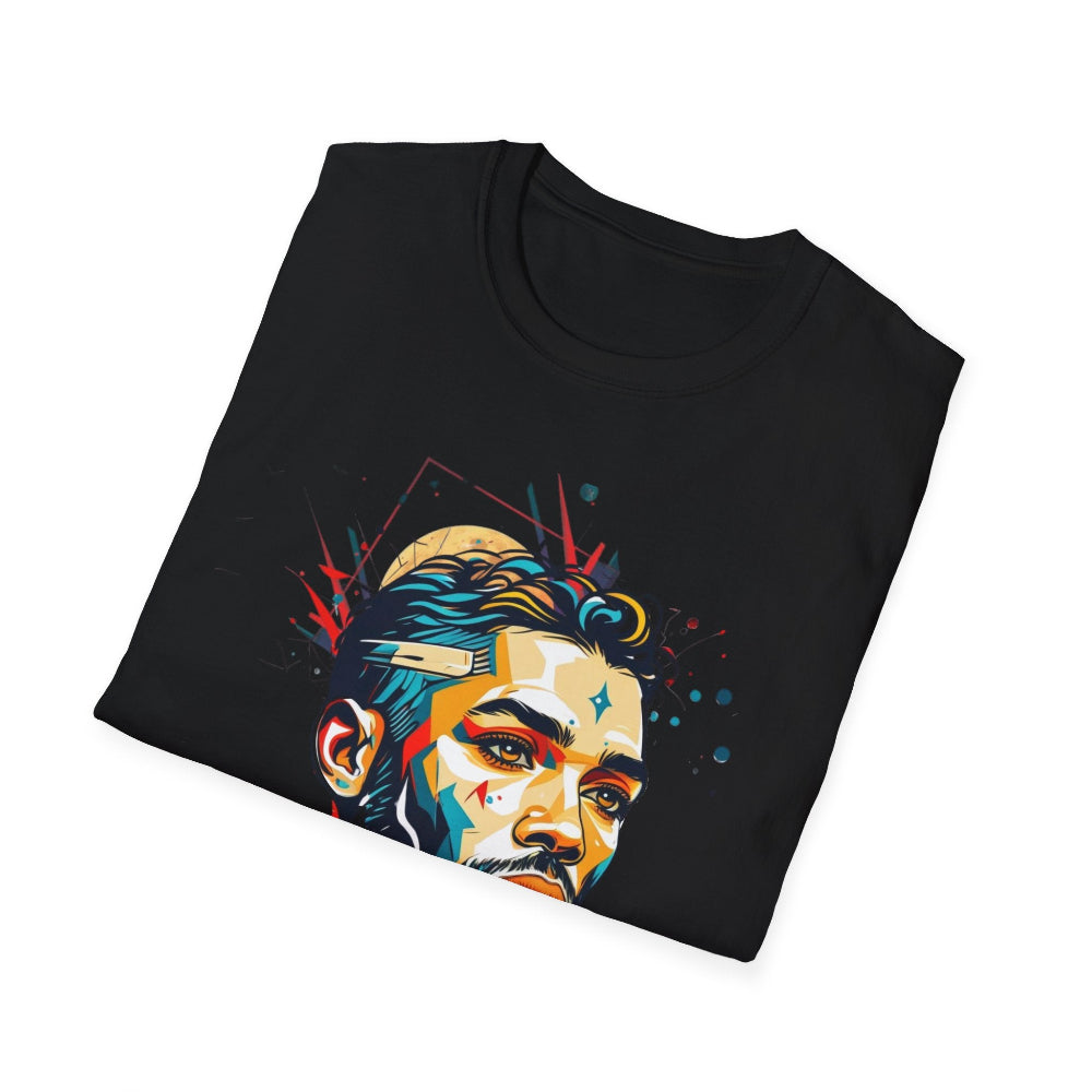 Black folded unisex cotton t-shirt featuring bold Primal graphic print: stylized intense bearded man portrait with short styled hair, vibrant multicolored geometric face in teal, orange, red, yellow, and blue tones, dynamic paint splatters, abstract shards, and red accent details exploding outward. Elegant white cursive "Primal" text below. Primal masculine energy motivational crewneck tee.