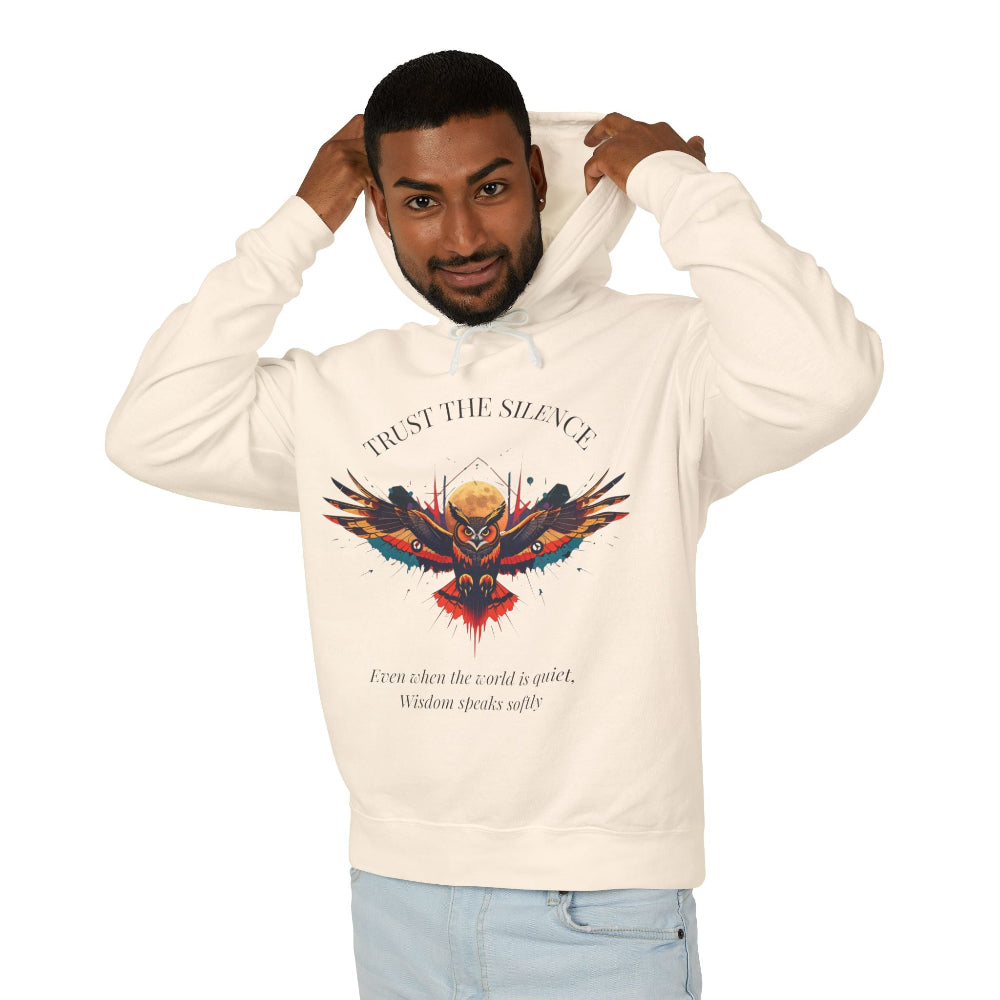 Man in cream trust the silence hoodie pulling up hood, colorful owl graphic and wisdom quote