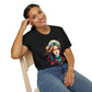 Black unisex cotton t-shirt modeled by smiling woman with braided hair, hand on cheek, featuring bold "Feral" graphic on chest: vibrant abstract portrait of a fierce woman with wild flowing multicolored hair, intense expression, tribal markings, colorful geometric accents, and dynamic paint splatters in red, orange, teal, blue, and gold tones bursting outward around an orange moon background. White elegant cursive "Feral" text below. Wild feminine energy motivational crewneck tee.