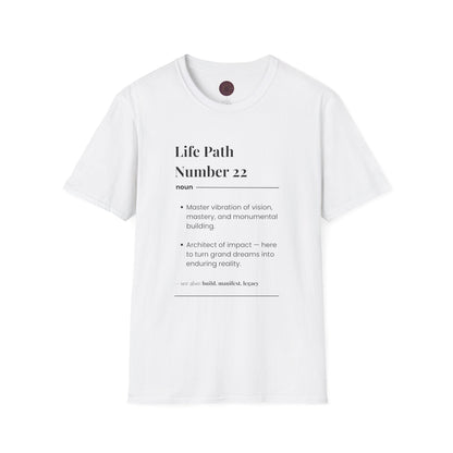 White unisex cotton t-shirt laid out flat featuring bold Life Path Number 22 numerology print in dictionary style: exact text reading "Life Path Number 22 noun · Master vibration of vision, mastery, and monumental building. · Architect of impact — here to turn grand dreams into enduring reality. – see also: build, manifest, legacy". Motivational spiritual numerology crewneck tee flat lay with visible purple/gold zodiac wheel inner tag.