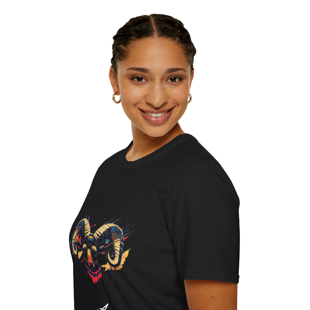 Black unisex cotton t-shirt in side profile on smiling woman with braided hair, featuring bold Aries zodiac graphic on chest: vibrant abstract ram head portrait with large curved horns, intense expression, geometric patterns, and dynamic multicolored paint splatters in gold, red, navy, teal, and black tones exploding outward. Elegant white cursive "Aries" text below. Astrology zodiac motivational crewneck tee.